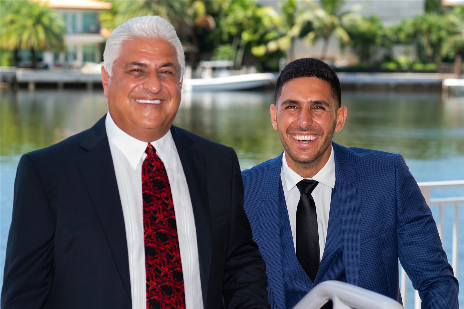 Yosi Gil and Guy Gil smiling together by the water