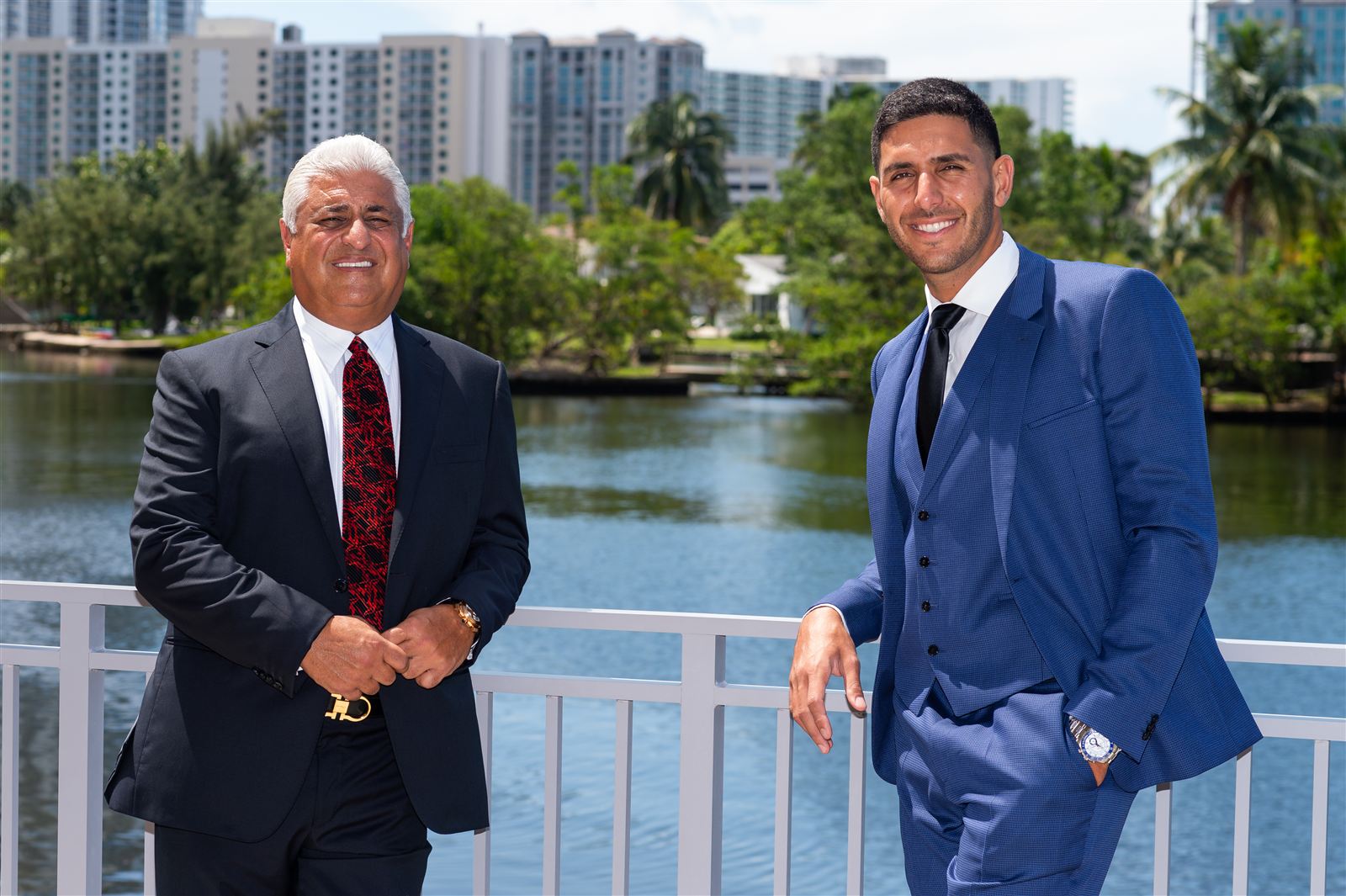 Yosi and Guy Gil on the waterfront with towers behind them